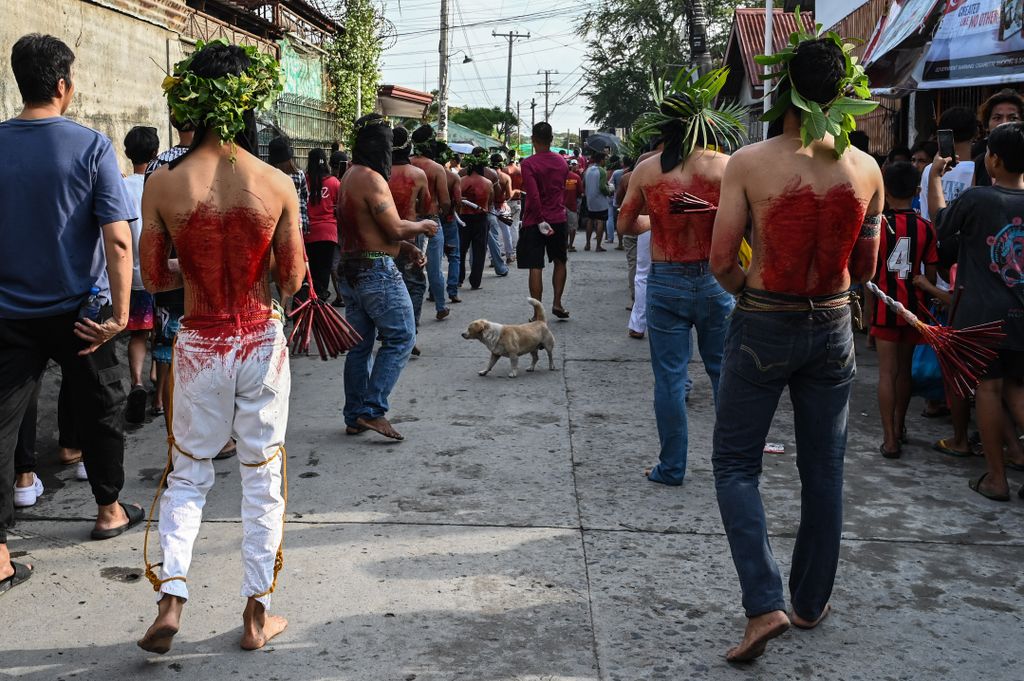 Penitents flagellate themselves during Good Friday as part of Holy Week celebrations in San Fernando, Pampanga province on March 29, 2024. (Photo by JAM STA ROSA / AFP)