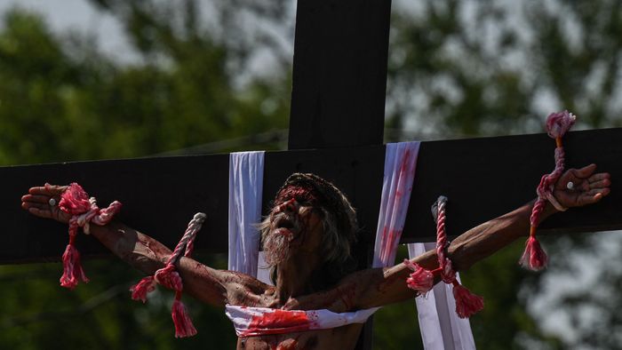 Philippine Christian devotee Wilfredo Salvador takes part in the re-enactment of the crucifixion of Jesus Christ on Good Friday in San Fernando, Pampanga province on March 29, 2024. (Photo by JAM STA ROSA / AFP)