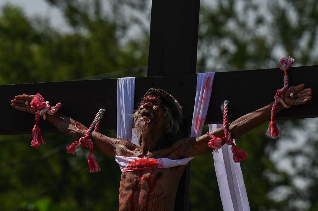 Philippine Christian devotee Wilfredo Salvador takes part in the re-enactment of the crucifixion of Jesus Christ on Good Friday in San Fernando, Pampanga province on March 29, 2024. (Photo by JAM STA ROSA / AFP)
