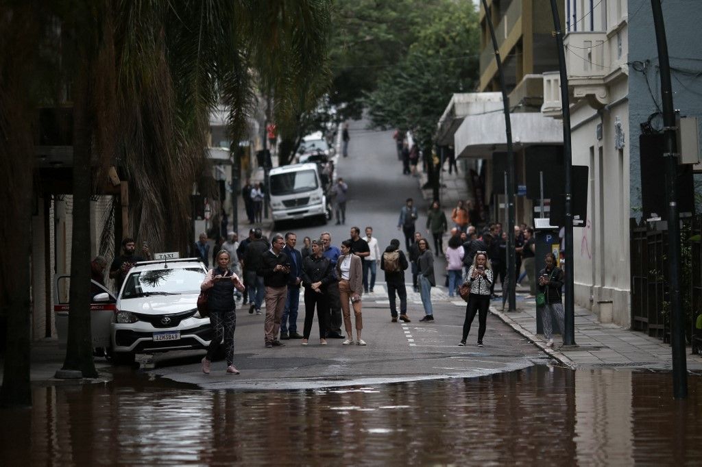 Az emberek egy elárasztott utcát figyelnek meg Porto Alegre történelmi központjában, Rio Grande do Sul államban, Brazíliában 2024. május 3-án. (Fotó: Anselmo Cunha / AFP)