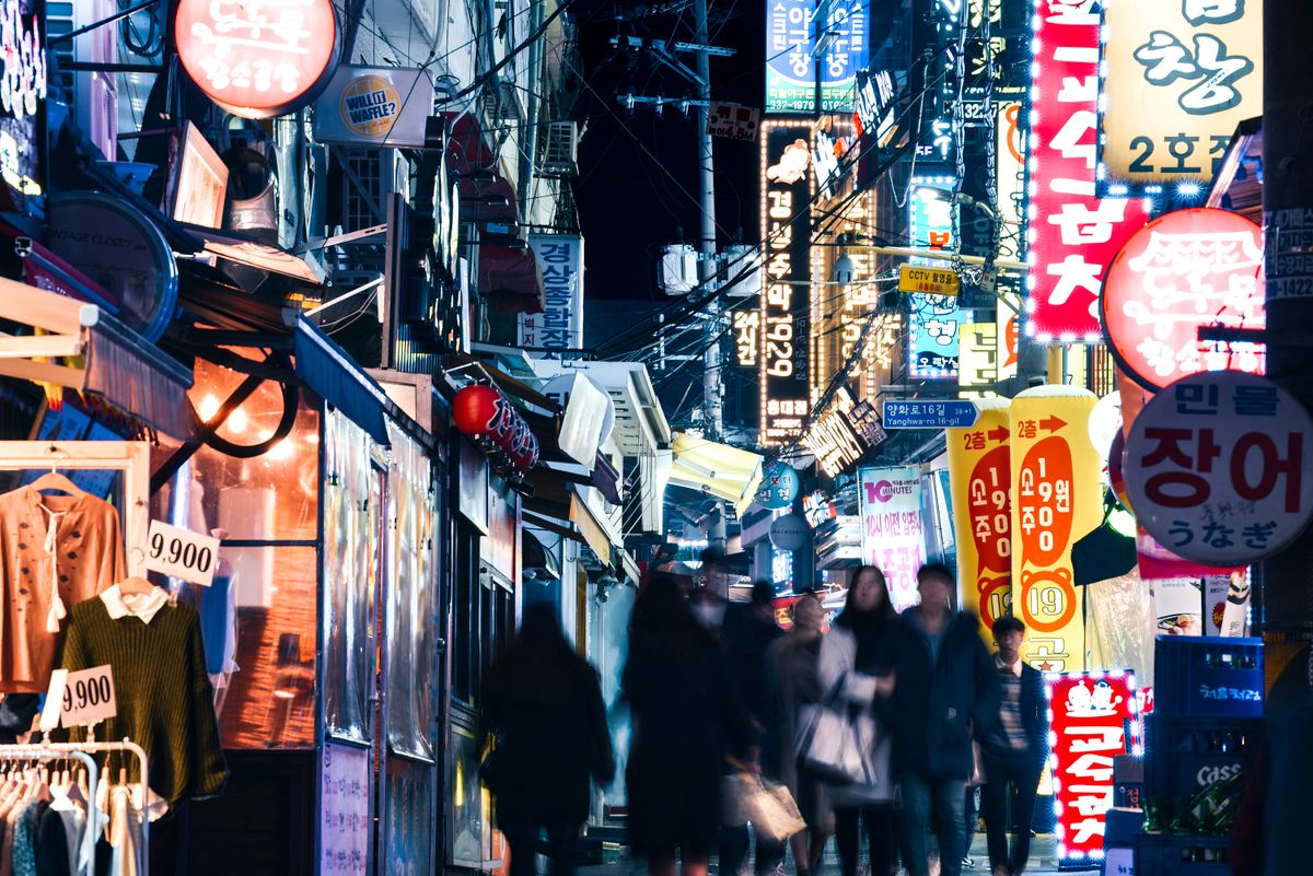 A bustling street scene at night in in Seoul's student district, Seoul, South Korea