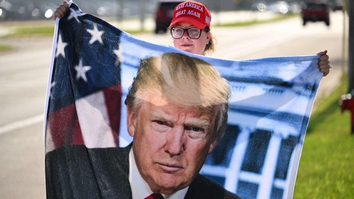 A supporter of Former US president and Republican presidential candidate Donald Trump waits by Milwaukee Mitchell International Airport, Wisconsin, on July 14, 2024, to try and get a glimpse of his plane landing. The Republican National Convention will take place from July 15th to the 18th. (Photo by Patrick T. Fallon / AFP)