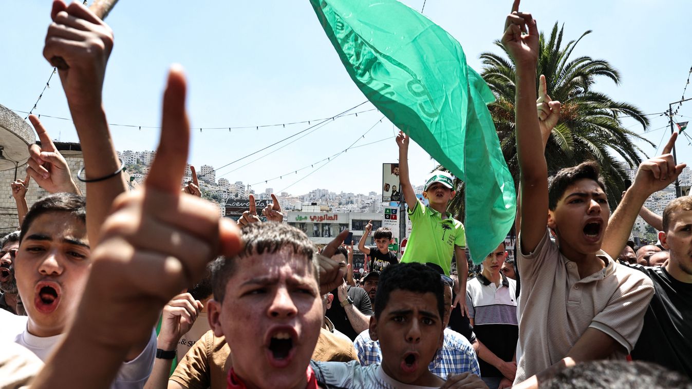 Palestinians attend a protest in Nablus in the Israeli-occupied West Bank following the assassination of the chief of the Palestinian Hamas militant group, on July 31, 2024. Hamas said its political leader Ismail Haniyeh was killed in an Israeli strike in Iran, where he was attending the swearing-in of the new president, and vowed the act "will not go unanswered". (Photo by Zain JAAFAR / AFP)