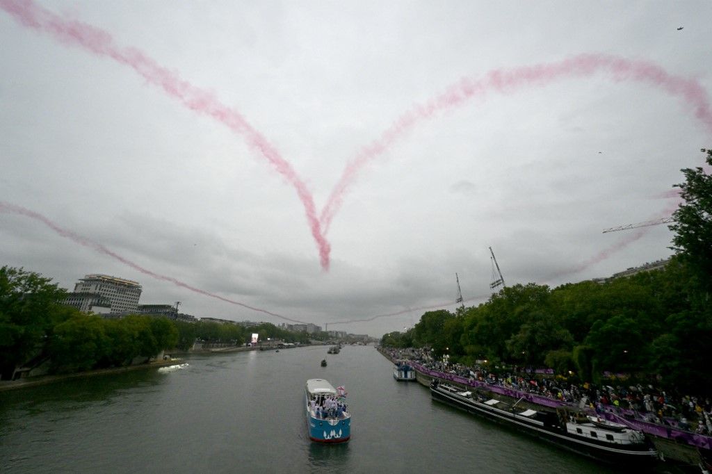 The Patrouille de France draws a heart in the sky during the opening ceremony of the Paris 2024 Olympic Games in Paris on July 26, 2024. (Photo by Damien MEYER / AFP)