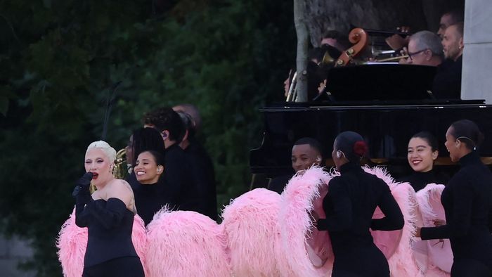 US' singer Lady Gaga sings at the Sully bridge area prior to the opening ceremony of the Paris 2024 Olympic Games in Paris on July 26, 2024. (Photo by Emmanuel DUNAND / AFP)