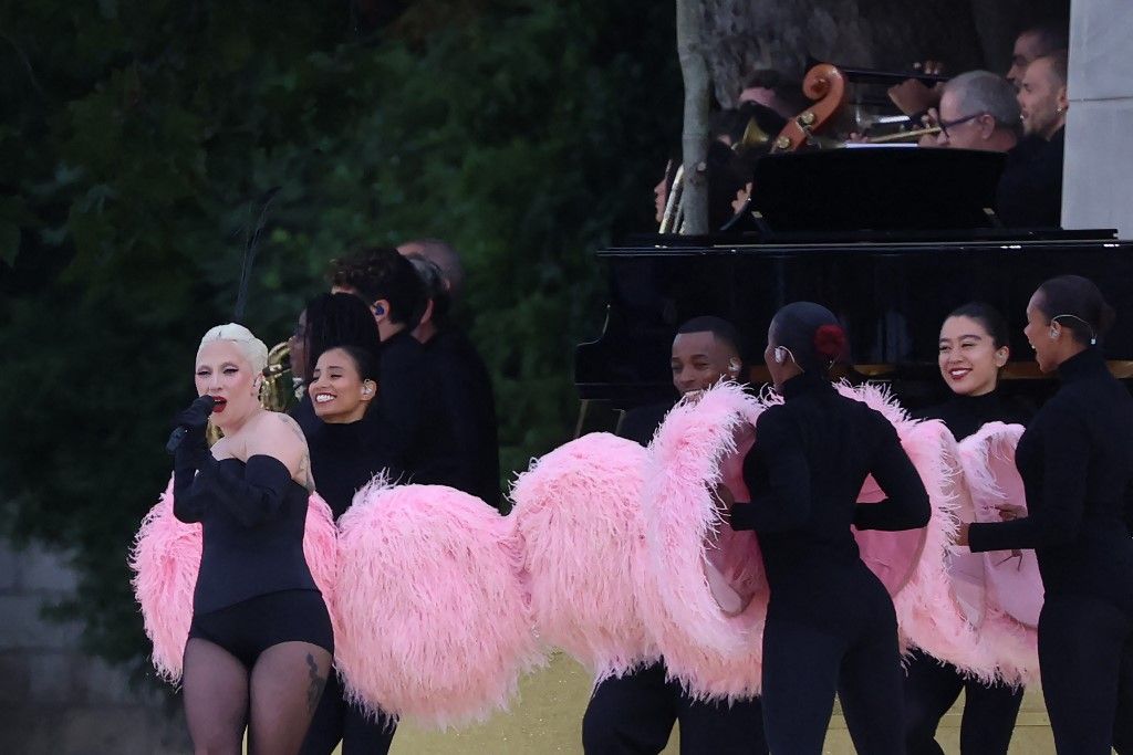 US' singer Lady Gaga sings at the Sully bridge area prior to the opening ceremony of the Paris 2024 Olympic Games in Paris on July 26, 2024. (Photo by Emmanuel DUNAND / AFP)