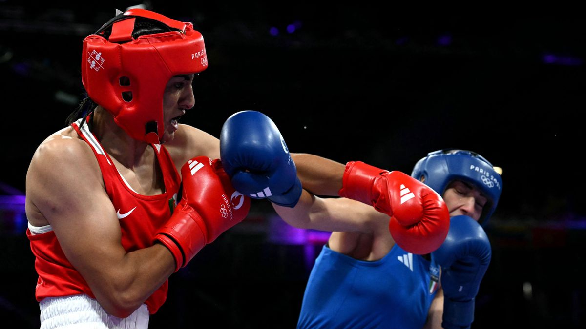 Algeria's Imane Khelif (in red) punches Italy's Angela Carini in the women's 66kg preliminaries round of 16 boxing match during the Paris 2024 Olympic Games at the North Paris Arena, in Villepinte on August 1, 2024. (Photo by MOHD RASFAN / AFP)