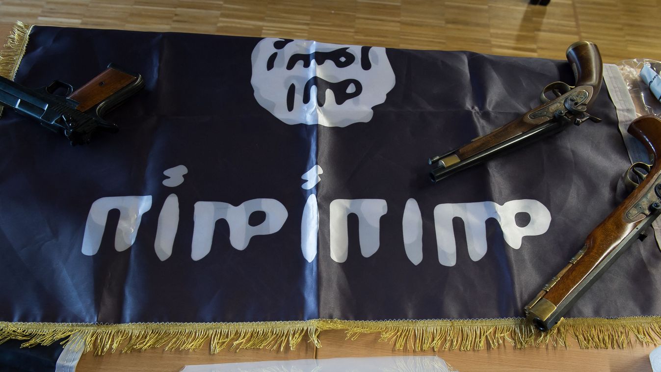 Confiscated items lie on a flag of ISIS on a table during a press conference at the police in Gottingen, central Germany, on February 9, 2017. An Algerian and a Nigerian suspected of preparing an assassination have been taken into custody during a raid, the police stated. (Photo by Swen Pfoertner / dpa / AFP) / Germany OUT