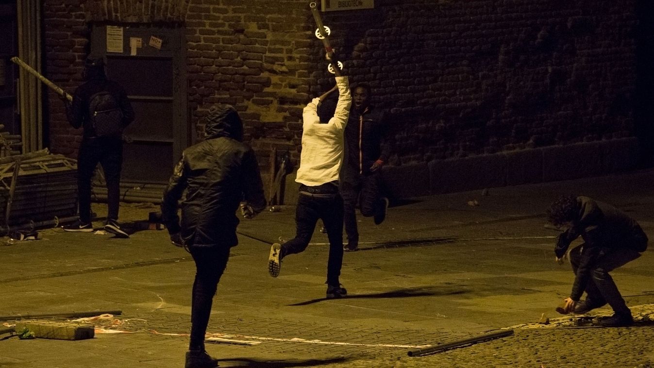 Protesters hold metal bars during a protest following the death of a street vendor at Lavapies district in Madrid on March 15, 2018. Migrants clashed with security forces in central Madrid today following the death of a Senegalese man whom they said was chased through the streets by police. Riot police and firefighters were deployed to Lavapies, a district in the centre of the Spanish capital with a large immigrant population, as angry protesters set fire to dustbins and a motorbike, and threw stones at security forces. (Photo by Olmo CALVO / AFP)