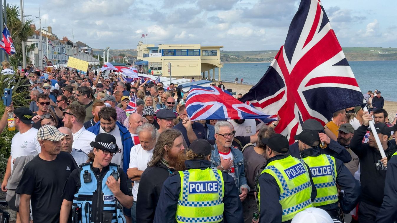 Far-right groups in England continue anti-immigrant protests, clash with counter-protesters
WEYMOUTH, UK - AUGUST 4: Far-right groups in England are continuing their anti-Muslim and anti-immigrant protests, heightening tensions following the tragic killing of three young girls in Southport last week, in United Kingdom on August 4, 2024. Far-right protesters clashed with British police at tense rallies as unrest spread across the UK over disinformation about a mass stabbing that killed three young girls. On Sunday, more than 100 people have been arrested following demonstrations organized by far-right groups that descended into disorder across several UK towns and cities. The unrest has affected areas, including Hull, Liverpool, Bristol, Manchester, Stoke-on-Trent, Blackpool, and Belfast, resulting in violence, looting, and attacks on police. Muhammed Yaylali / Anadolu (Photo by Muhammed Yaylali / ANADOLU / Anadolu via AFP)