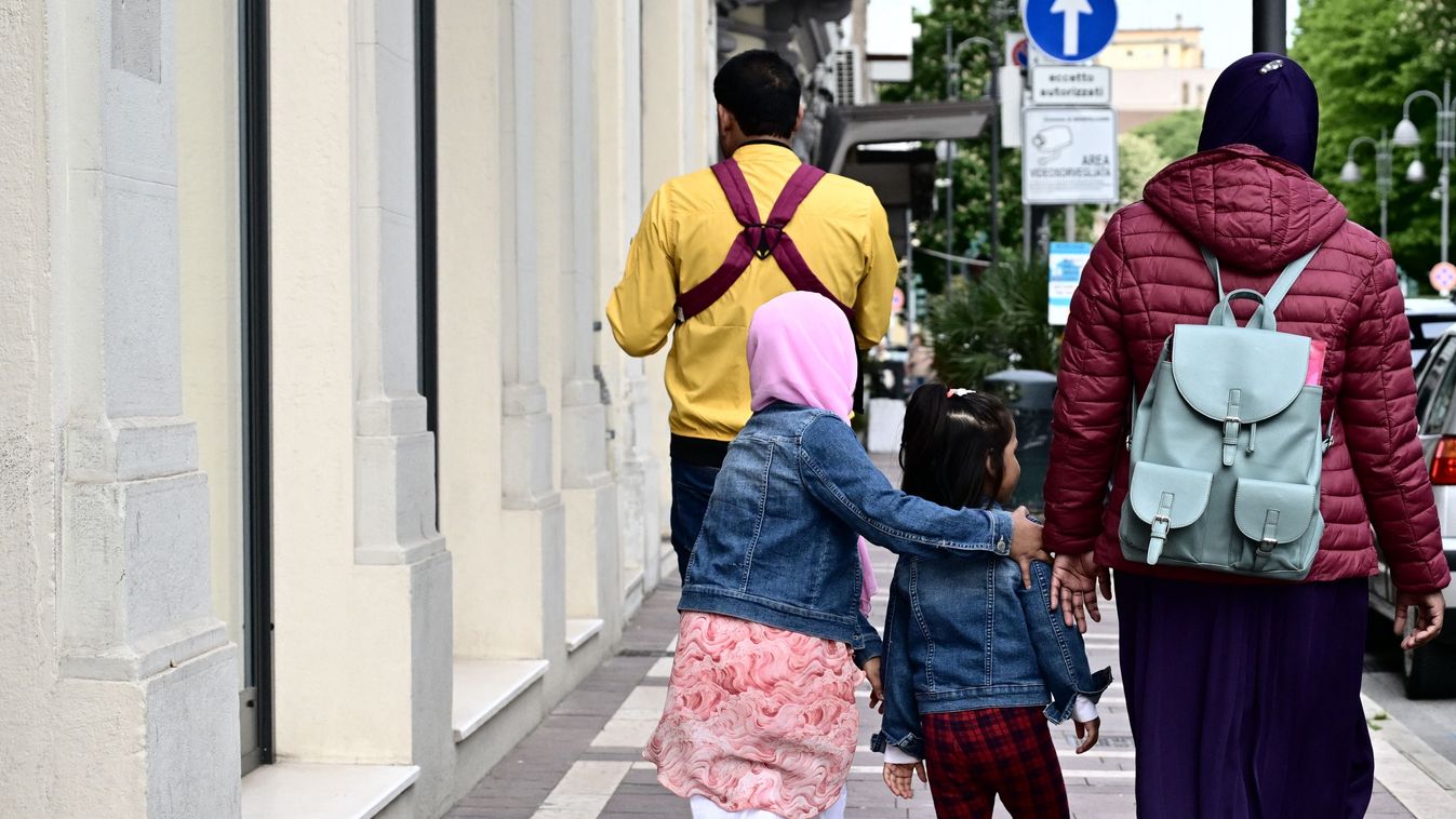 A muslim family walks in a street of Monfalcone, on April 26, 2024. The far-right mayor of Monfalcone, Anna Maria Cisint, was under the spotlights recently because she banned muslims from praying inside their two cultural centers. An administrative court in Trieste will rule on May 23, 2024 whether to uphold or strike down the mayor's ban. Immigrants make up a third of Monfalcone of 30,000 inhabitants outside Trieste, most of them Bangladeshi Muslims who began arriving in the late 1990s to build cruise-liners for Fincantieri, Europe's largest shipbuilder.  Since November a fraction of the city's Muslims who have been banned from praying inside their two cultural centres by Monfalcone's far-right mayor. (Photo by Alberto PIZZOLI / AFP)