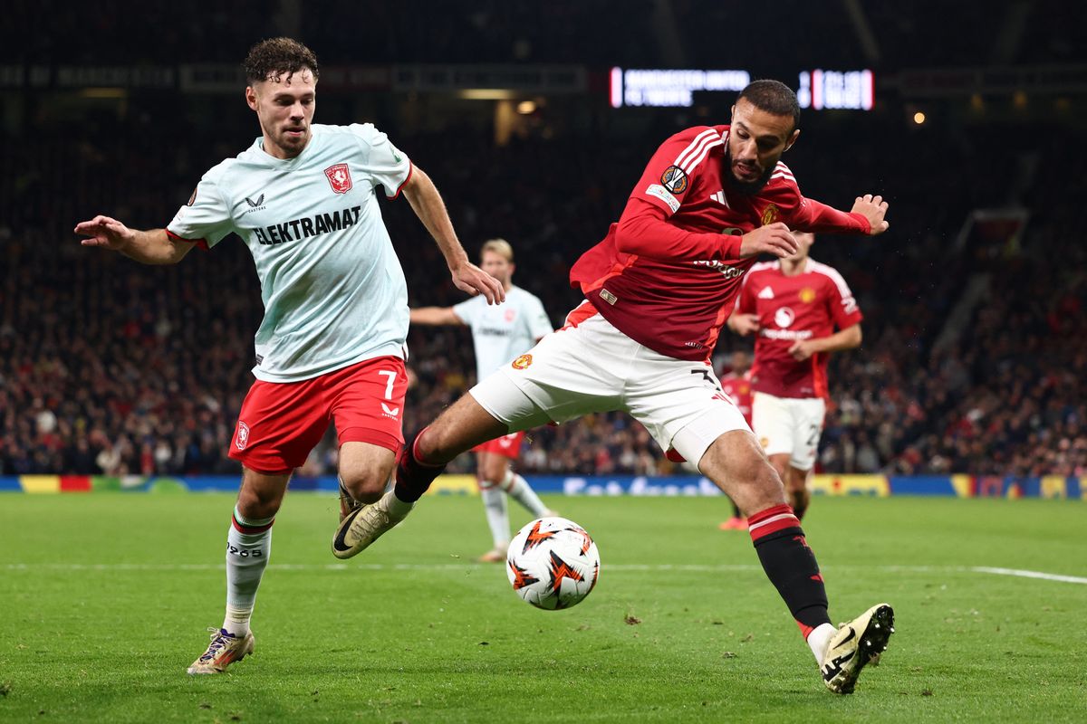 Manchester United's Moroccan defender #03 Noussair Mazraoui (R) vies for the ball with FC Twente's Dutch forward #07 Mitchell Van Bergen during the UEFA Europa league stage football match between Manchester United and FC Twente at Old Trafford stadium in Manchester, north west England, on September 25, 2024. (Photo by Darren Staples / AFP)