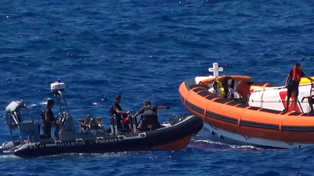 This grab from a video taken by Local Team shows migrants rescued for days by NGO Proactiva Open Arms charity ship, being rescued by a Spanish patrol boat after throwing themselves in the water to try and swim to the nearby Italian island of Lampedusa in a desperate move after days stuck on board, on August 20, 2019. The NGO Proactiva Open Arms that owns the ship warned the situation was "out of control" as Spain announced it would make a new attempt at solving a standoff between the vessel and Italy, which refuses them port access. (Photo by LOCALTEAM / AFP) / RESTRICTED TO EDITORIAL USE - MANDATORY CREDIT "AFP PHOTO / LOCAL TEAM"- NO MARKETING - NO ADVERTISING CAMPAIGNS - DISTRIBUTED AS A SERVICE TO CLIENTS