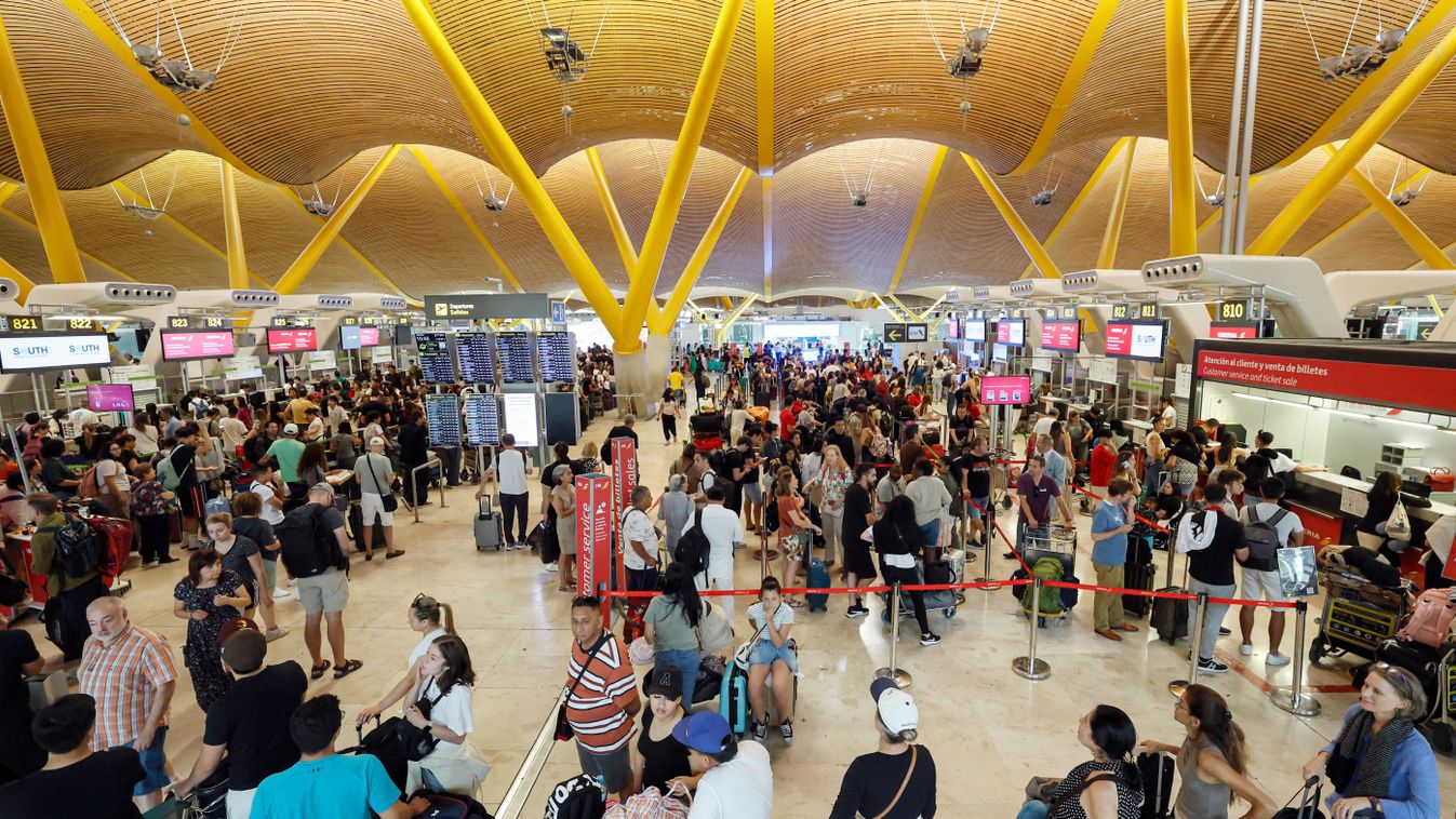 Passengers stand in terminal 4 of Adolfo Suarez Madrid–Barajas Airport in Madrid on July 19, 2024, amid massive global IT outage. Airlines, banks, TV channels and other business across the globe were scrambling to deal with one of the biggest IT crashes in recent years on July 19, 2024, caused by an update to an antivirus program. (Photo by OSCAR DEL POZO / AFP)