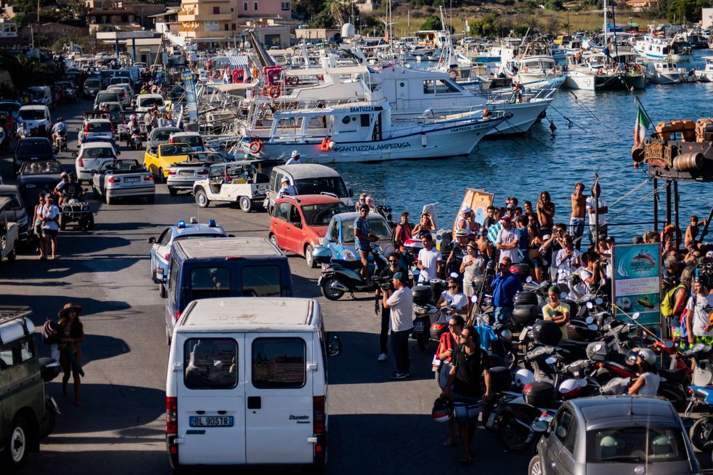 Twenty-seven unaccompanied minors leave the harbour in Lampedusa in police vans on August 17, 2019, after being evacuated from the Spanish migrant NGO rescue ship Open Arms moored off the coast of the island. Twenty-seven unaccompanied minors have been authorised to leave a migrant rescue vessel in limbo off Italy, the Spanish charity operating the ship said. Italian Far-right Interior Minister Matteo Salvini wrote in a letter to Prime Minister Giuseppe Conte that he could authorise the "alleged" minors to leave the Open Arms ship despite such a move being "divergent to my orientation." (Photo by Alessandro SERRANO / AFP) / Italy OUT