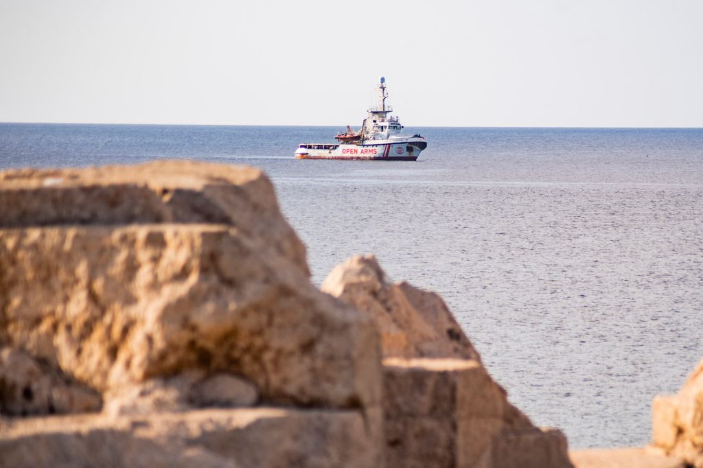 The Spanish migrant rescue NGO ship Open Arms is seen off the coast of the Italian island of Lampedusa on August 17, 2019. Twenty-seven unaccompanied minors have been authorised to leave a migrant rescue vessel in limbo off Italy, the Spanish charity operating the ship said. Italian Far-right Interior Minister Matteo Salvini wrote in a letter to Prime Minister Giuseppe Conte that he could authorise the "alleged" minors to leave the Open Arms ship despite such a move being "divergent to my orientation." (Photo by Alessandro SERRANO / AFP) / Italy OUT