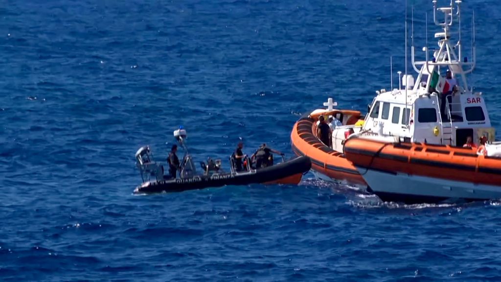 This grab from a video taken by Local Team shows migrants rescued for days by NGO Proactiva Open Arms charity ship, being rescued by a Spanish patrol boat after throwing themselves in the water to try and swim to the nearby Italian island of Lampedusa in a desperate move after days stuck on board, on August 20, 2019. The NGO Proactiva Open Arms that owns the ship warned the situation was "out of control" as Spain announced it would make a new attempt at solving a standoff between the vessel and Italy, which refuses them port access. (Photo by LOCALTEAM / AFP) / - Italy OUT / RESTRICTED TO EDITORIAL USE - MANDATORY CREDIT "AFP PHOTO / LOCAL TEAM"- NO MARKETING - NO ADVERTISING CAMPAIGNS - DISTRIBUTED AS A SERVICE TO CLIENTS