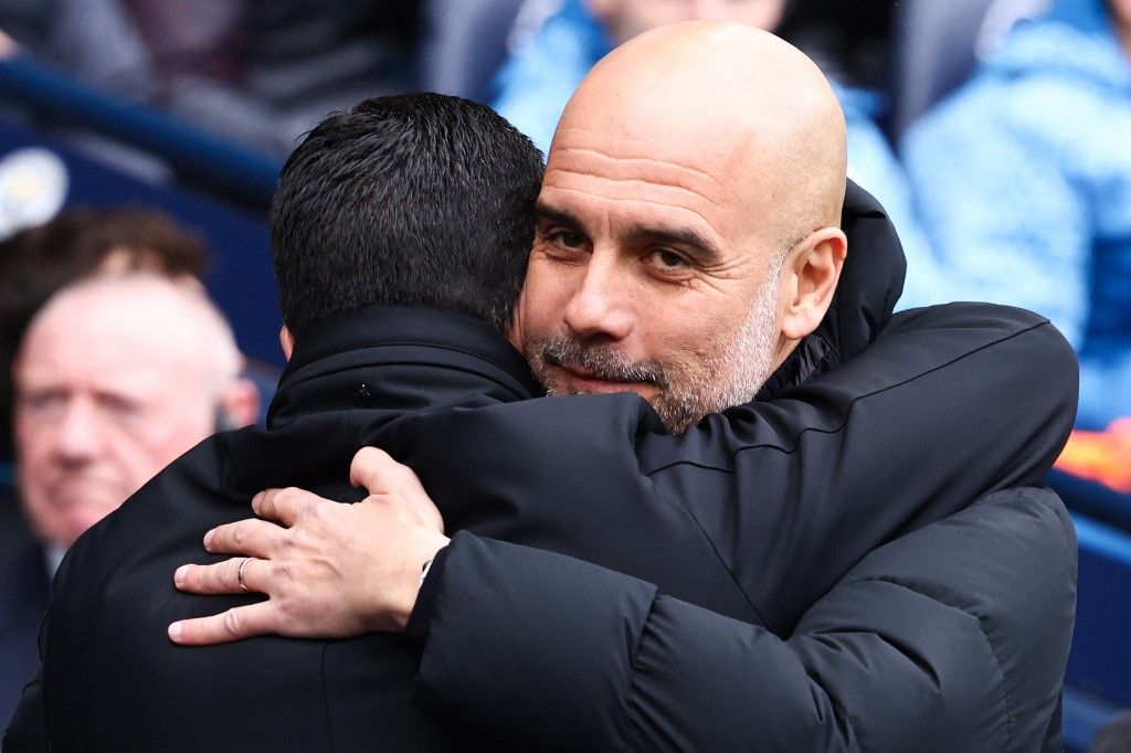 Arsenal's Spanish manager Mikel Arteta (L) and Manchester City's Spanish manager Pep Guardiola hugh each other during the English Premier League football match between Manchester City and Arsenal at the Etihad Stadium in Manchester, north west England, on March 31, 2024. (Photo by Darren Staples / AFP) / RESTRICTED TO EDITORIAL USE. No use with unauthorized audio, video, data, fixture lists, club/league logos or 'live' services. Online in-match use limited to 120 images. An additional 40 images may be used in extra time. No video emulation. Social media in-match use limited to 120 images. An additional 40 images may be used in extra time. No use in betting publications, games or single club/league/player publications. / 