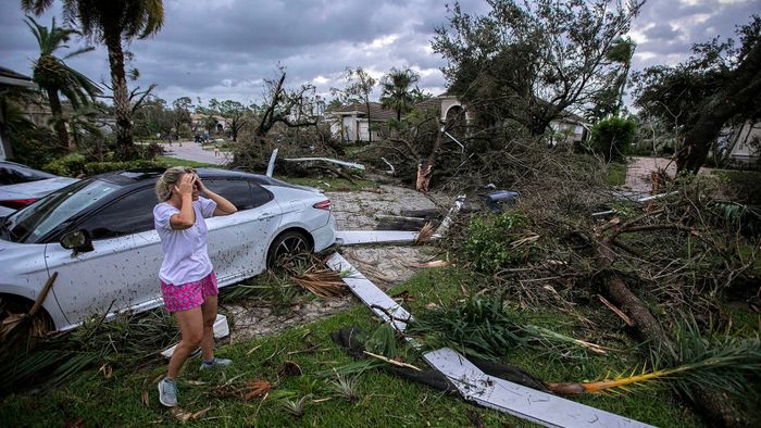 Marie Cook reacts to the damage to her home in the Binks Estates community after a tornado formed by Hurricane Milton touched down