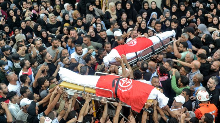 Mourners in the Nahr al-Bared camp for Palestinian refugees gather for the funeral of commanders of the Popular Front For the Liberation of Palestine (PFLP) group who were killed by an overnight Israeli air strike in Beirut, at the camp near Lebanon's northern city of Tripoli on September 30, 2024. (Photo by Fathi AL-MASRI / AFP)