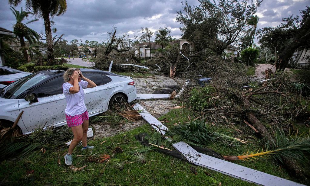 Marie Cook reacts to the damage to her home in the Binks Estates community after a tornado formed by Hurricane Milton touched down