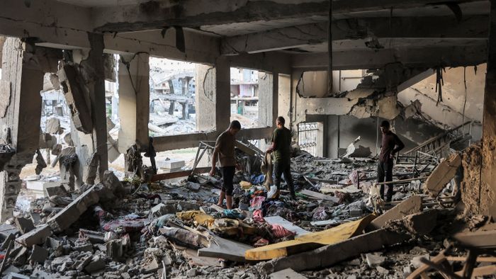 People inspect a destroyed classroom in the aftermath of Israeli bombardment on the Palestinian Muscat Governmental School, funded by Omani aid, in Gaza City on October 2, 2024 amid the ongoing war in the Palestinian territory between Israel and Hamas. (Photo by Omar AL-QATTAA / AFP)