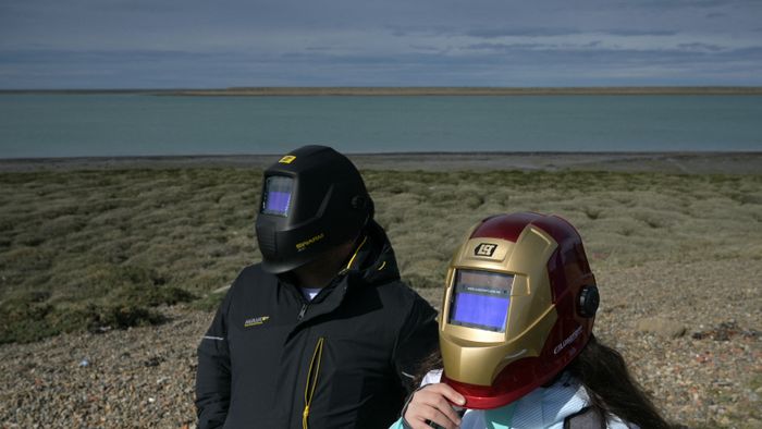 People wear a protective mask to watch the solar annular eclipse in Puerto San Julian, Santa Cruz province, Argentina, on October 2, 2024 (Photo by Juan MABROMATA / AFP)