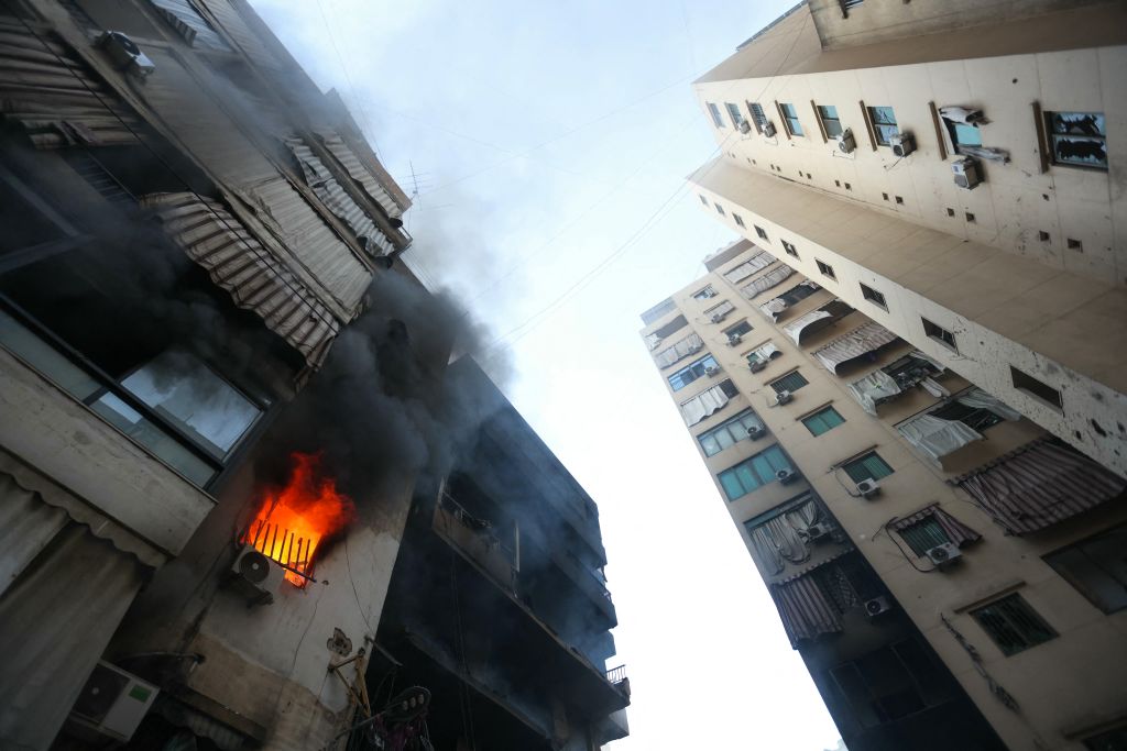 A fire burns in a damaged building at the site of overnight Israeli airstrikes on the Chiah neighbourhood in Beirut's southern suburbs on October 4, 2024. (Photo by Ibrahim AMRO / AFP)