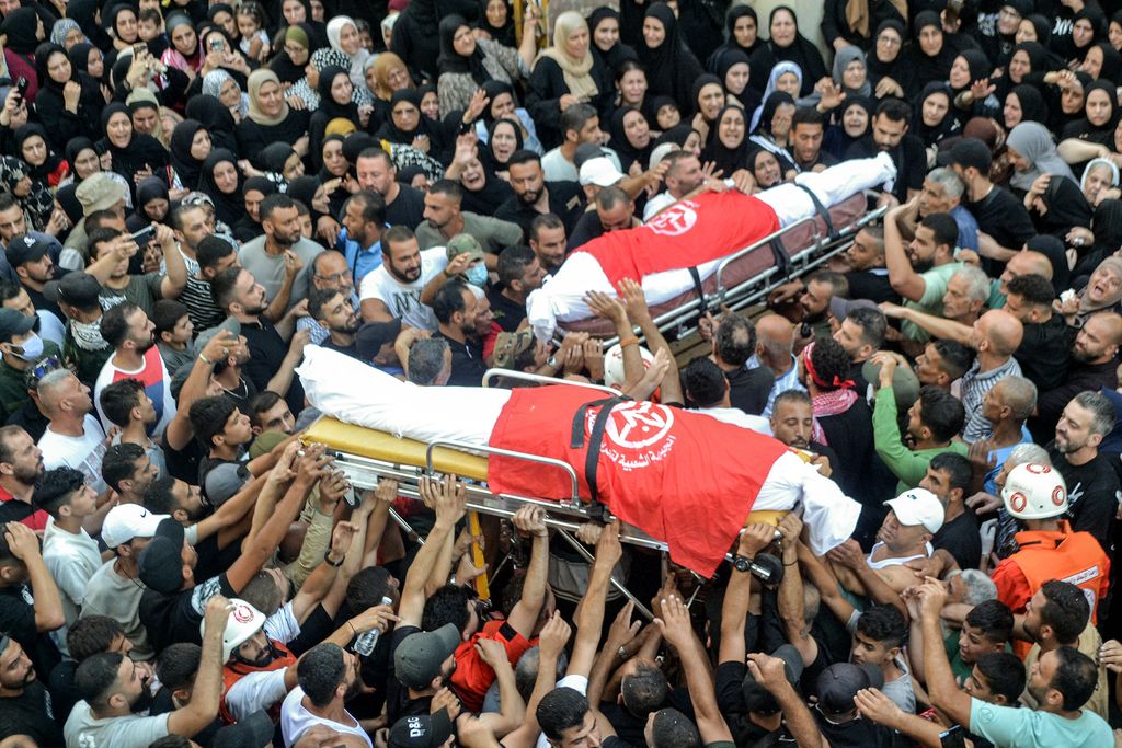 Mourners in the Nahr al-Bared camp for Palestinian refugees gather for the funeral of commanders of the Popular Front For the Liberation of Palestine (PFLP) group who were killed by an overnight Israeli air strike in Beirut, at the camp near Lebanon's northern city of Tripoli on September 30, 2024. (Photo by Fathi AL-MASRI / AFP)