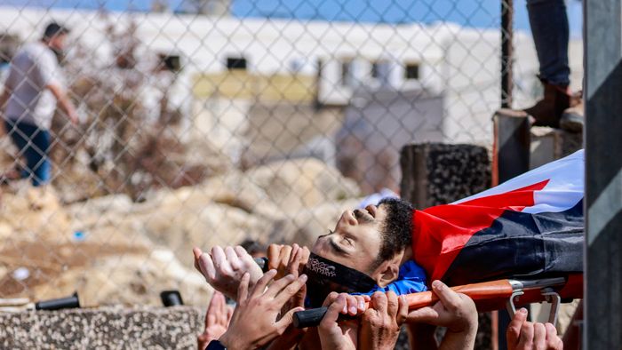 EDITORS NOTE: Graphic content / Mourners carry the body of Palestinian Deya Dwakat who was killed in an Israeli military raid the previous day in the occupied West Bank, during a funeral in Balatah on October 2, 2024. (Photo by Jaafar ASHTIYEH / AFP)