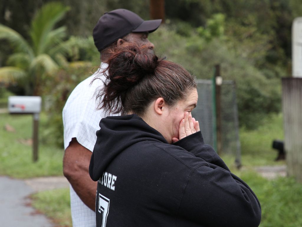 Resident of Kissimmee observes a tree which fell on his house in the wake of Hurricane Milton in Florida