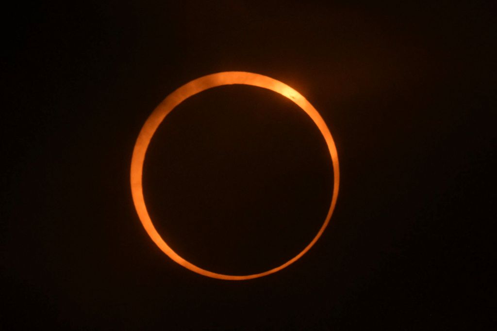 A man prepares his camera to view the annular solar eclipse at Isla de Pascua in the Pacific Ocean, Chile, on October 2, 2024. Part of the southern hemisphere will witness this Wednesday an annular eclipse that will occur when the Moon almost totally covers the Sun, leaving a luminous ring visible, a spectacle that will be seen in its maximum splendor from the Chilean and Argentinean Patagonia. (Photo by Jonathan MARTINS / AFP)