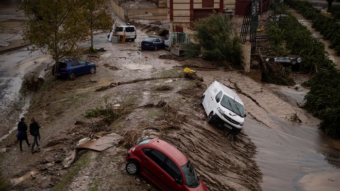 Cars taken in a mudslide are pictured in a flooded street in Alora, near Malaga, on October 30, 2024, after heavy rains hit southern Spain. Heavy rains hit southern Spain on October 30, 2024. Floods in eastern Valencia region has left at least 70 people dead. (Photo by JORGE GUERRERO / AFP)