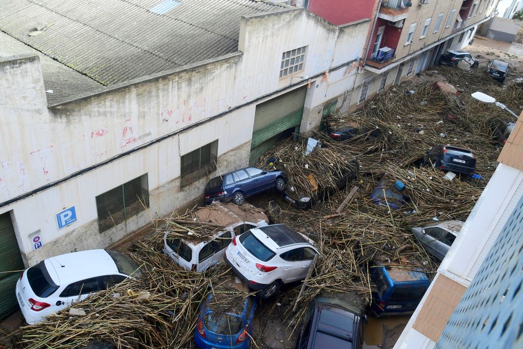 A picture taken in Picanya, near Valencia, eastern Spain, on October 30, 2024 shows cars piled in a stree after floods. Floods triggered by torrential rains in Spain's eastern Valencia region has left 51 people dead, rescue services said on October 30. (Photo by Jose Jordan / AFP)