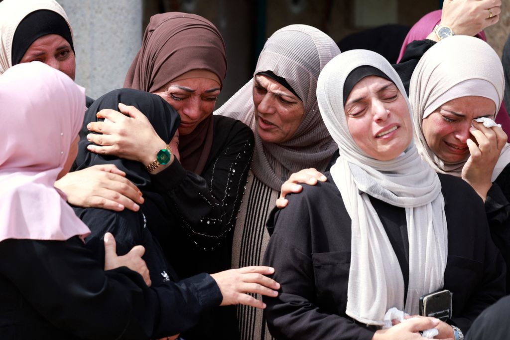 EDITORS NOTE: Graphic content / Mourners attend the funeral of Palestinian Deya Dwakat who was killed in an Israeli military raid the previous day in the occupied West Bank, in Balatah on October 2, 2024. (Photo by Jaafar ASHTIYEH / AFP)