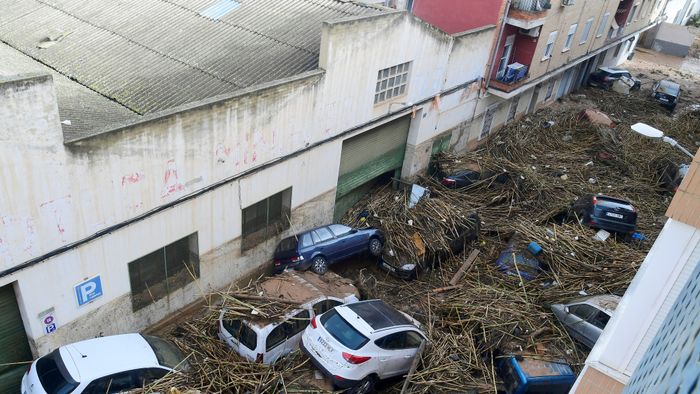 A picture taken in Picanya, near Valencia, eastern Spain, on October 30, 2024 shows cars piled in a stree after floods. Floods triggered by torrential rains in Spain's eastern Valencia region has left 51 people dead, rescue services said on October 30. (Photo by Jose Jordan / AFP)