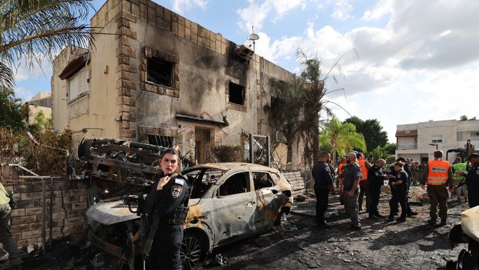 First responders and Israeli security forces gather amid debris and charred vehicles in Kiryat Bialik in the Haifa district of Israel, following a reported strike by Lebanon's Hezbollah on September 22, 2024. Hezbollah said on September 22 that it targeted military production facilities and an air base near north Israel's Haifa after the Israeli military pounded south Lebanon and said it targeted thousands of rocket launcher barrels. (Photo by Jack GUEZ / AFP)