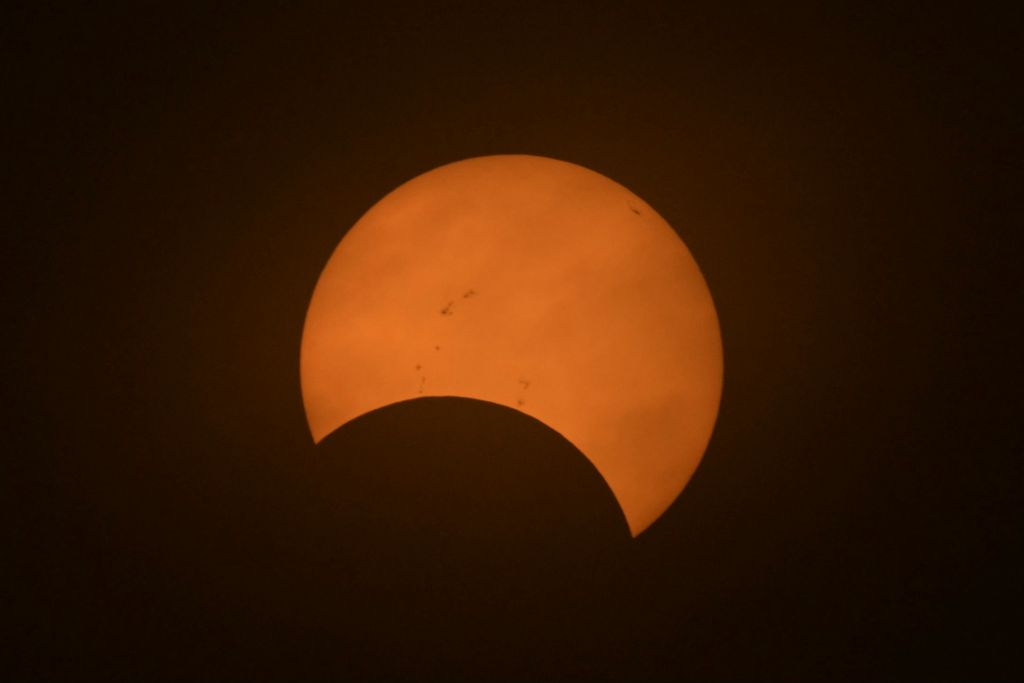 Partial view of the solar annular eclipse in Puerto San Julian, Santa Cruz province, Argentina, taken on October 2, 2024 (Photo by Juan MABROMATA / AFP)