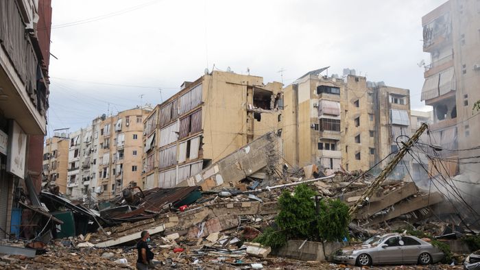 A man looks at the destruction at the site of an overnight Israeli airstrike on the Bir el-Abed neighbourhood in Beirut's southern suburbs on October 1, 2024.. (Photo by ANWAR AMRO / AFP)