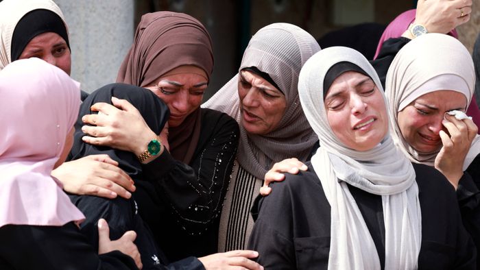 EDITORS NOTE: Graphic content / Mourners attend the funeral of Palestinian Deya Dwakat who was killed in an Israeli military raid the previous day in the occupied West Bank, in Balatah on October 2, 2024. (Photo by Jaafar ASHTIYEH / AFP)