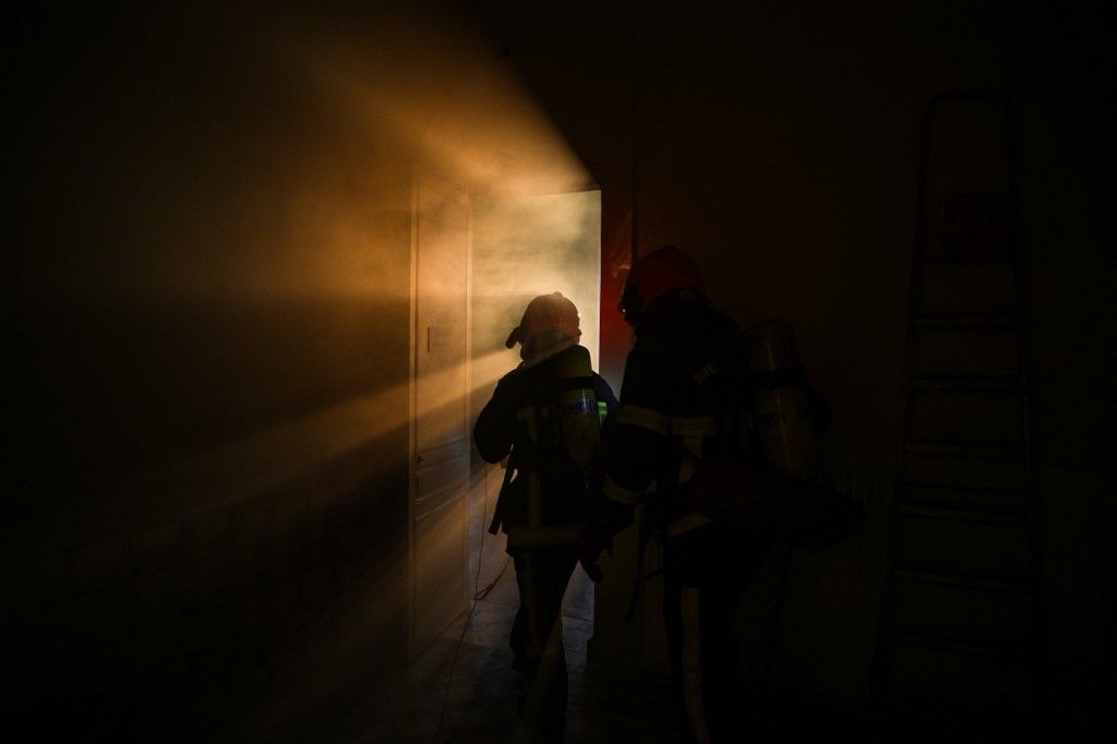 A firefighter takes part in a fire safety training by the SDIS 01 firemen organisation in the castle Bouchet in Fareins, central-eastern France, on November 27, 2024. (Photo by OLIVIER CHASSIGNOLE / AFP)