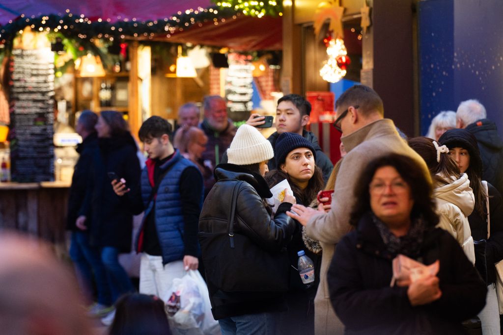 ChristmaVisitors check the stalls selling Christmas decorations at Cologne Christmas in front of Dam Cathedral in Cologne, Germany, on November 18, 2024. (Photo by Ying Tang/NurPhoto) (Photo by Ying Tang / NurPhoto / NurPhoto via AFP)s Market Opens In Cologne