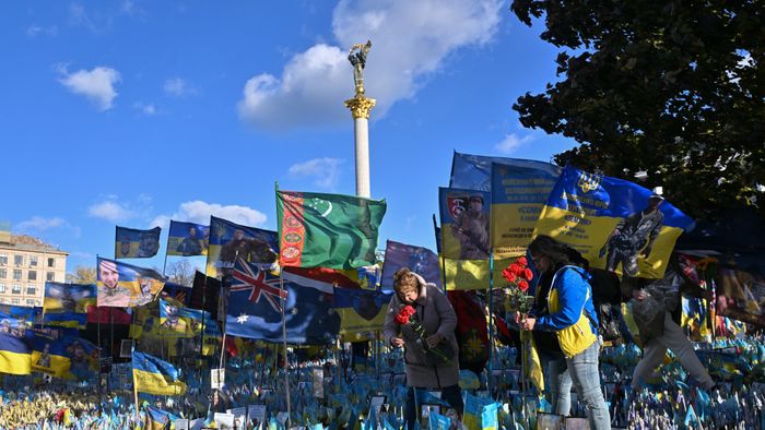 Women lay flowers in tribute to fallen Ukrainian soldiers at a makeshift memorial at Independence Square in Kyiv, on November 2, 2024, amid the Russian invasion in Ukraine. (Photo by Sergei SUPINSKY / AFP)