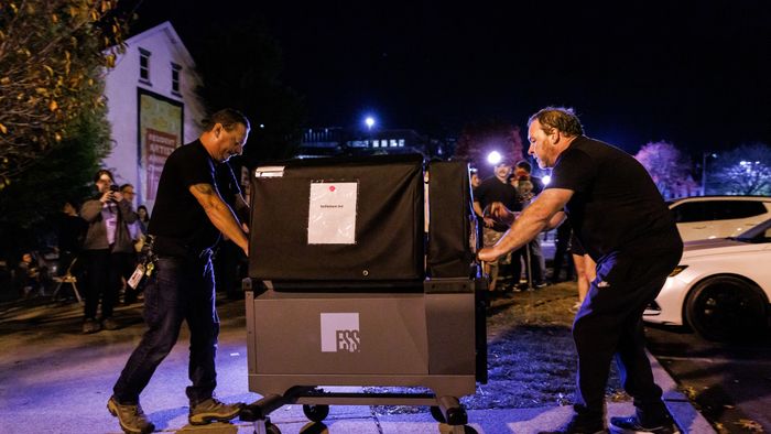 Workers deliver an additional voting machine to the polling location in the Banana Factory in the 3rd Ward of Bethlehem, Pennsylvania on November 5, 2024. The 3rd Ward polling location faced long lines from the start after one of the two voting machines broke early in the day and college students from Lehigh University flocked to cast their ballots causing as much as a six hour wait. (Photo by SAMUEL CORUM / AFP)