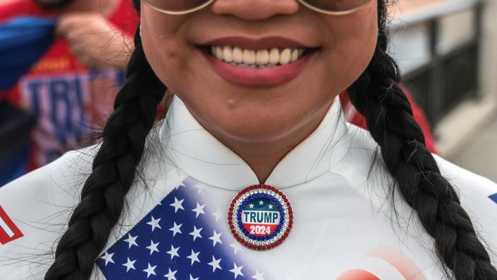 A supporter of former US President and Republican presidential candidate Donald Trump wears a "Trump 2024" pin near his Mar-a-Lago resort in Palm Beach, Florida, on Election Day, November 5, 2024. (Photo by Giorgio Viera / AFP)