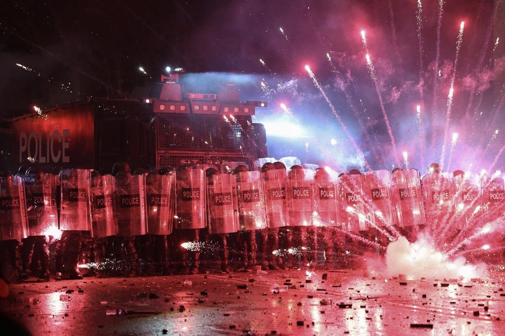  Police tries to disperse protesters during a demonstration against the government's decision to delay EU membership talks, near the Parliament building in downtown Tbilisi early on November 30, 2024. Georgian police fired water cannon and tear gas on demonstrators on the second day to protest the government putting off EU membership talks. The Black Sea nation has been rocked by turmoil since the ruling Georgian Dream party declared victory in last month parliamentary elections that the pro-EU opposition decried as falsified. (Photo by Giorgi ARJEVANIDZE / AFP)