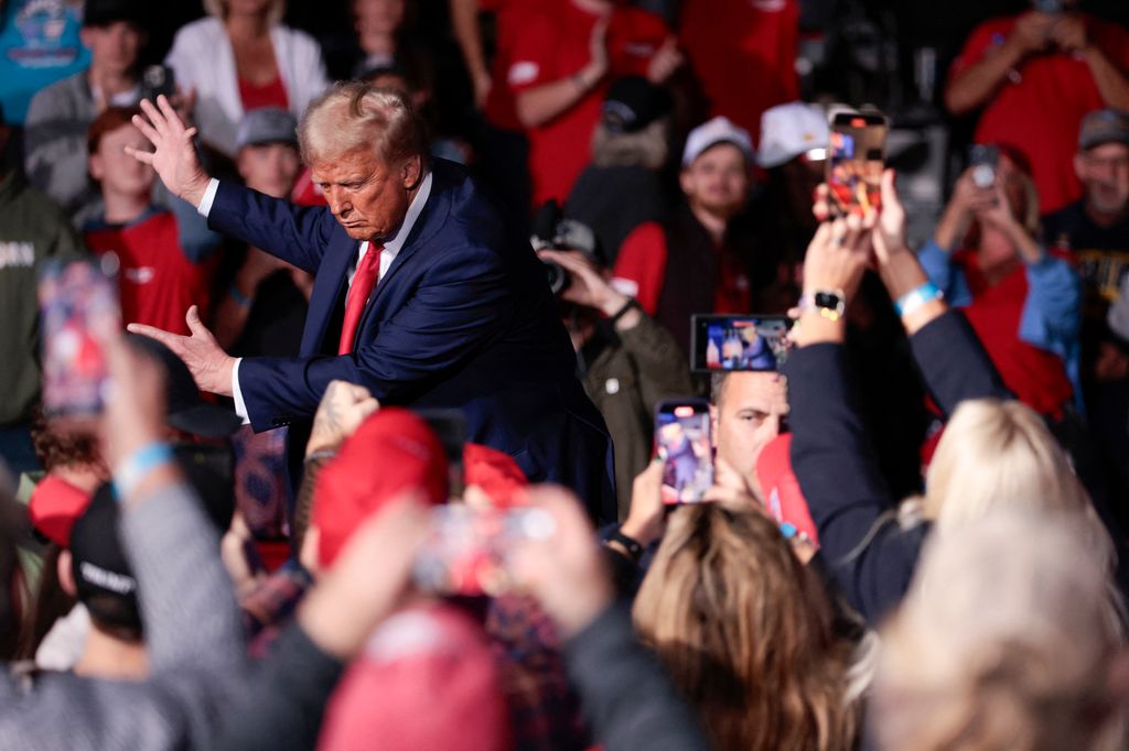 Former US President and Republican presidential candidate Donald Trump dances as he leaves after speaking at his last campaign rally at Van Andel Arena in Grand Rapids, Michigan on November 5, 2024. (Photo by JEFF KOWALSKY / AFP)