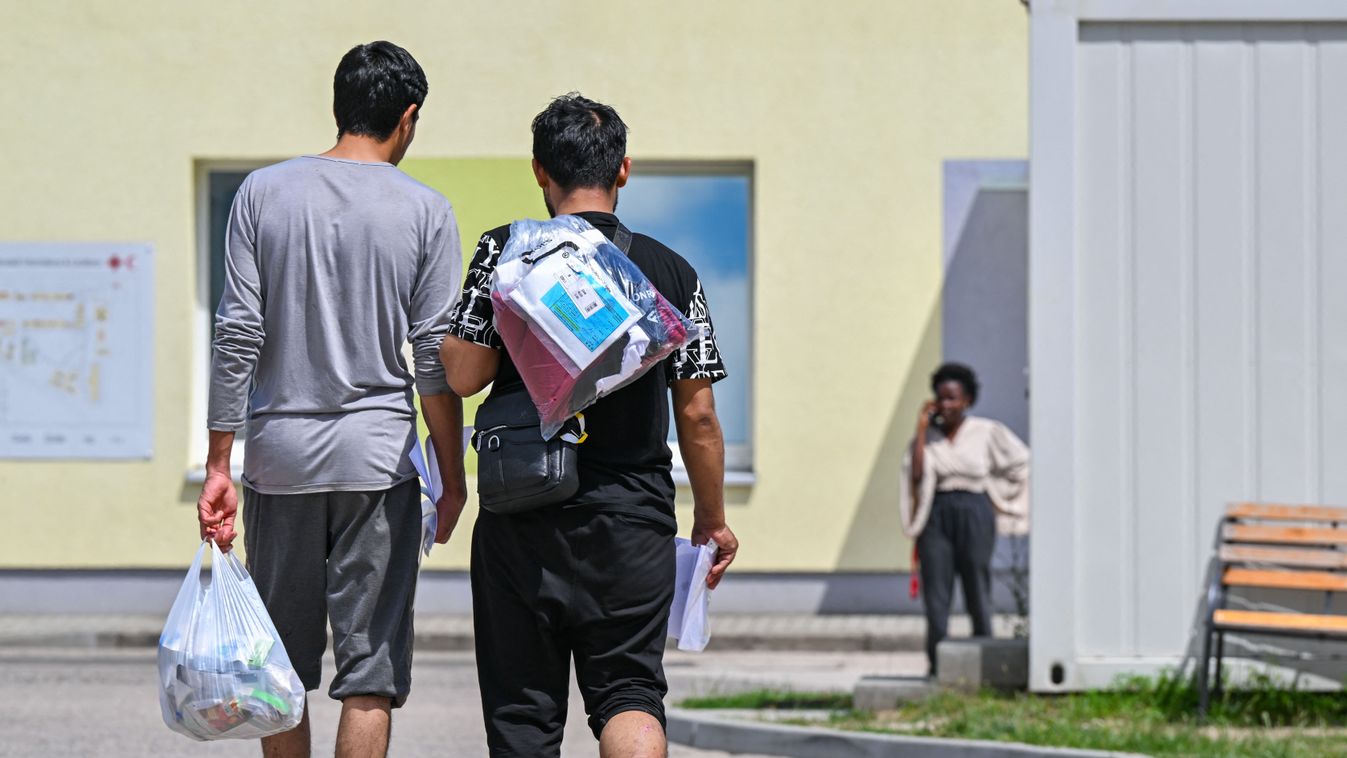 Central initial reception center for asylum seekers
18 June 2024, Brandenburg, Eisenhüttenstadt: Two migrants walk across the grounds of the Central Reception Center for Asylum Seekers (ZABH) in the state of Brandenburg. On June 20, the Conference of Minister Presidents will discuss the question of whether asylum procedures for asylum seekers can be transferred to a cooperating state outside the EU while respecting international and human rights law. Photo: Patrick Pleul/dpa (Photo by PATRICK PLEUL / DPA / dpa Picture-Alliance via AFP)