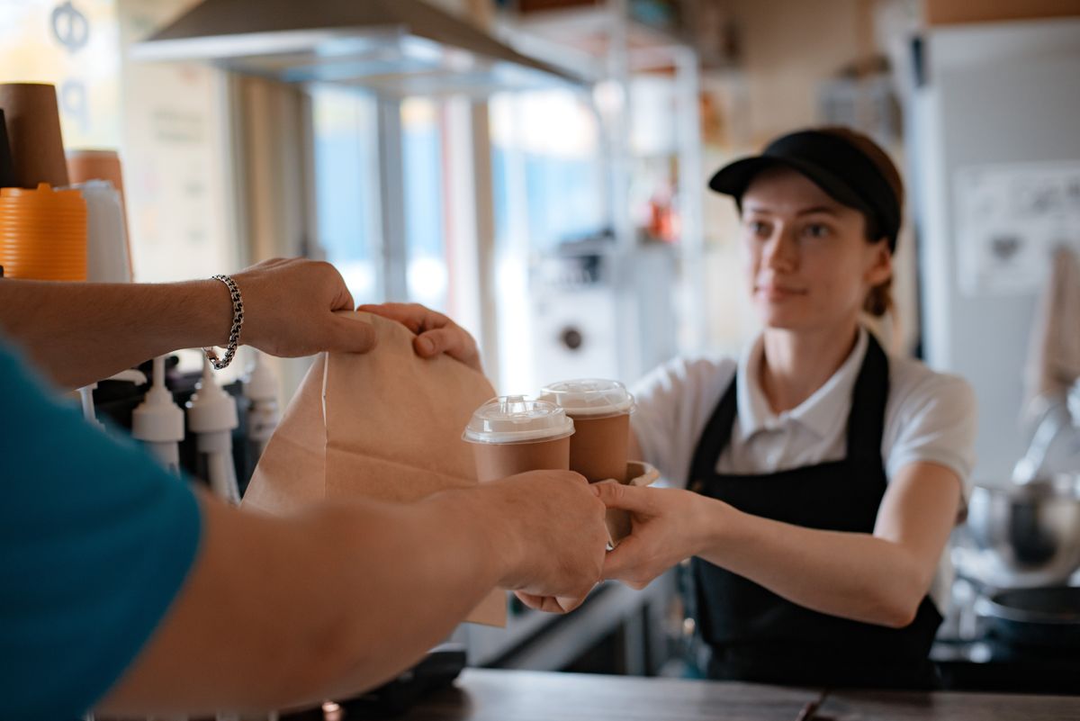 Buying,Fast,Food.,A,Pancake,With,Filling,And,A,Paper