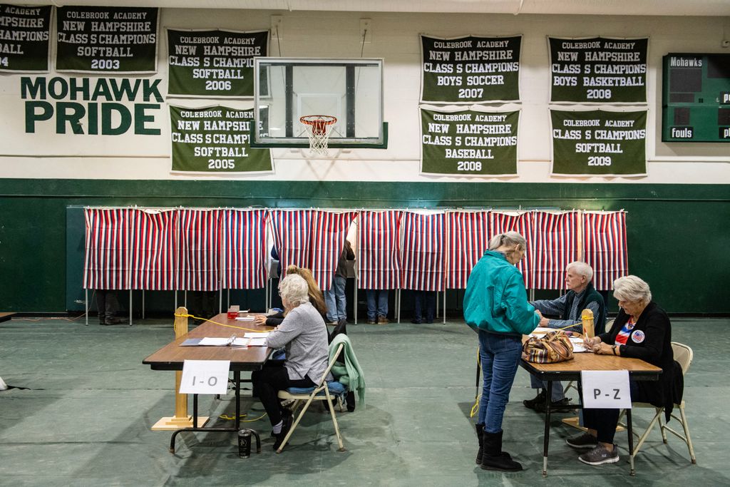 A woman checks in to vote at a polling station at Colebrook Academy and Elementary School in Colebrook, New Hampshire, on Election Day, November 5, 2024. (Photo by Joseph Prezioso / AFP)